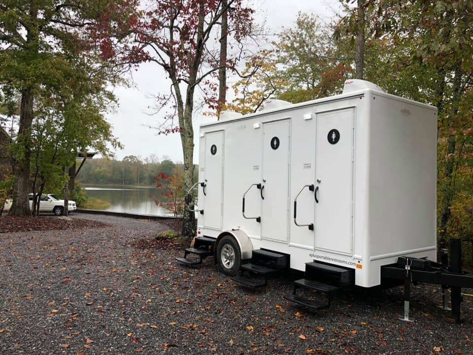 Portable restroom trailer setup at a construction site